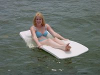 Don't Let Me Fall In!  Sheri lays on the mat from Steve's boat