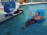 In the Basket!  Adam plays basketball from his comfy lounger in the pool
