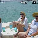 Ladies of the Sun  Chris, Sheri, & Liz relax with a cocktail on the boat : Cliff Poulter