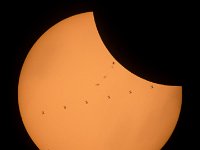 2017 Total Solar Eclipse - ISS Transit  This composite image, made from seven frames, shows the International Space Station, with a crew of six onboard, as it transits the Sun at roughly five miles per second during a partial solar eclipse, Monday, Aug. 21, 2017 near Banner, Wyoming. Onboard as part of Expedition 52 are: NASA astronauts Peggy Whitson, Jack Fischer, and Randy Bresnik; Russian cosmonauts Fyodor Yurchikhin and Sergey Ryazanskiy; and ESA (European Space Agency) astronaut Paolo Nespoli. A total solar eclipse swept across a narrow portion of the contiguous United States from Lincoln Beach, Oregon to Charleston, South Carolina. A partial solar eclipse was visible across the entire North American continent along with parts of South America, Africa, and Europe.  Photo Credit: (NASA/Joel Kowsky) : International Space Station (ISS), Partial Solar Eclipse, Sun, Transit, Wyoming